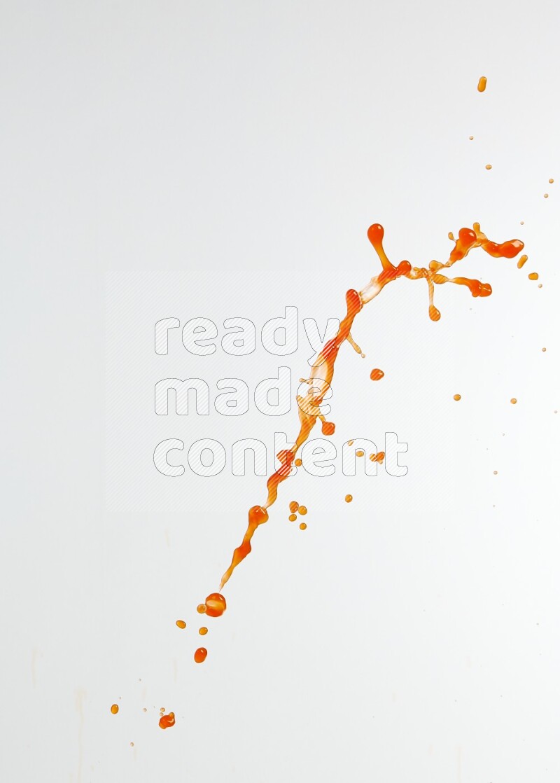 Orange liquid splash and drops on white background