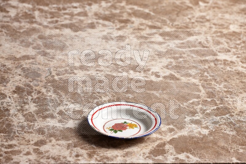A vintage metal plate on beige marble background
