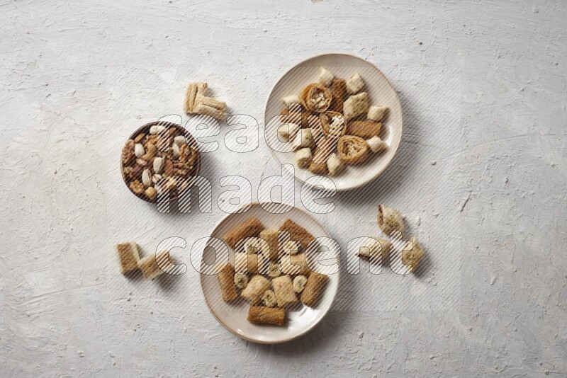 Oriental sweets in pottery plates with nuts in a light setup
