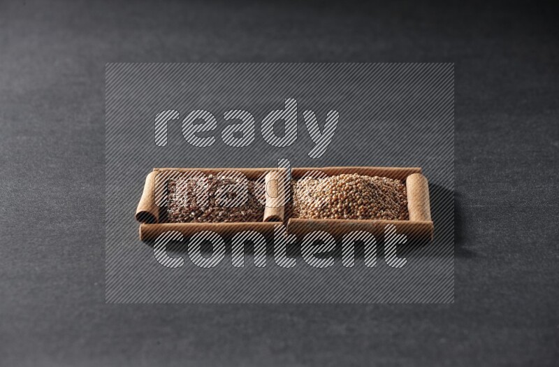 2 squares of cinnamon sticks full of mustard seeds and flaxseeds on black flooring