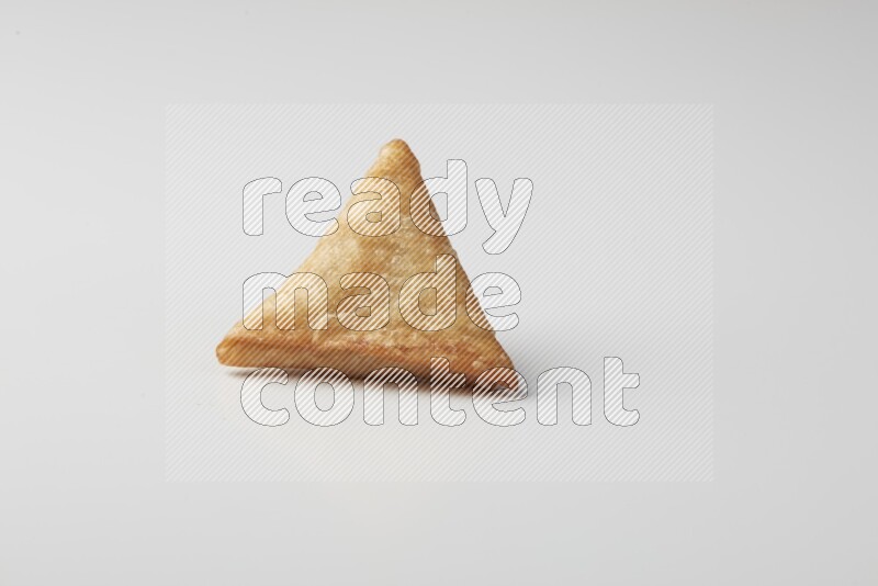 One fried sambosa on a white background