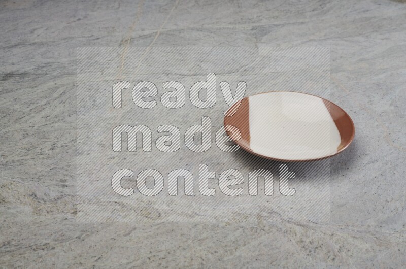 Multicolored Pottery Plate On Grey Marble Flooring