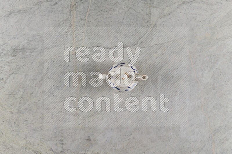 A pottery teapot on grey marble background