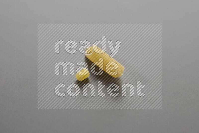 Small rings pasta with other types of pasta on grey background