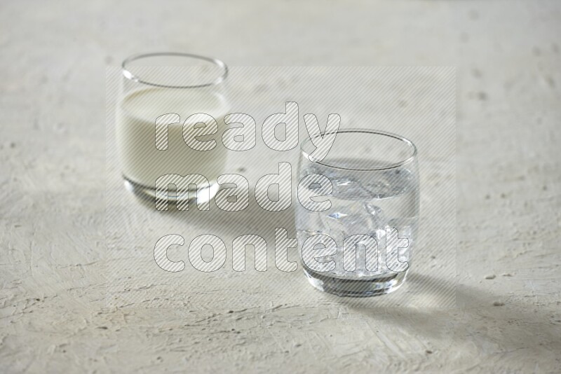 Cold drinks in a glass cup such as water, tamarind, qamar eldin, sobia, milk and hibiscus on textured white background