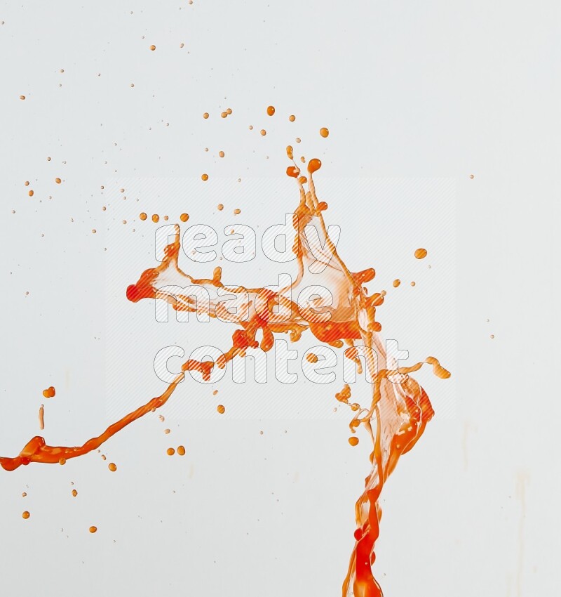 Orange liquid splash and drops on white background