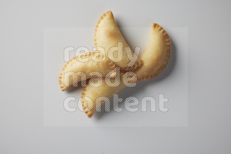 Four fried sambosa from a top angle on a white background