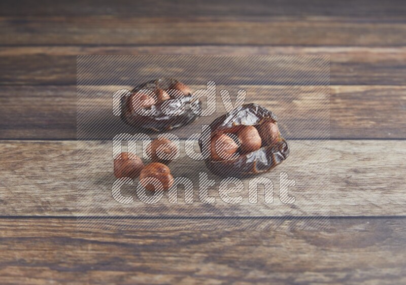 two hazelnut stuffed madjoul date on a wooden background