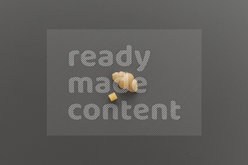 Small rings pasta with other types of pasta on grey background