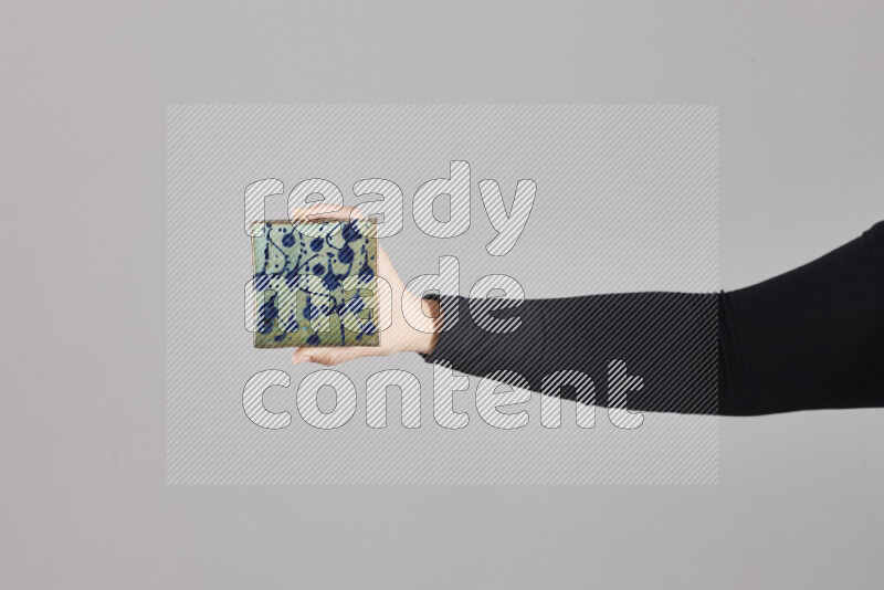 A woman in black abaya holding different pottery essentials in different positions