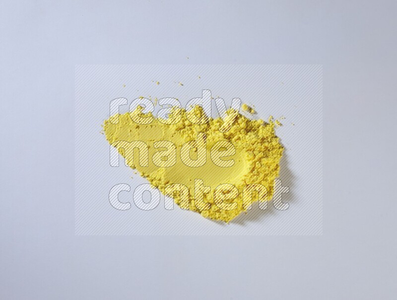 Yellow powder smears on white background