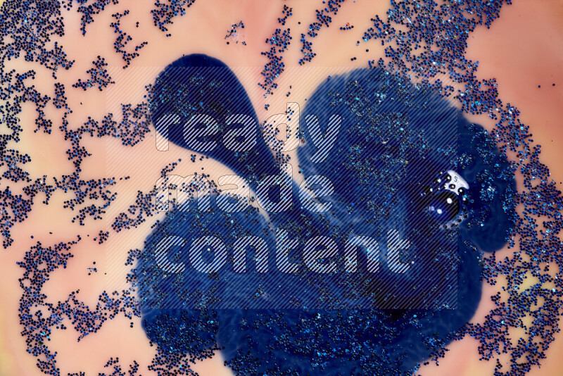 لقطة مقربة لبريق أزرق متلألئ منتشر على خلفية من اللون الأزرق والبرتقالي في حركات دائرية