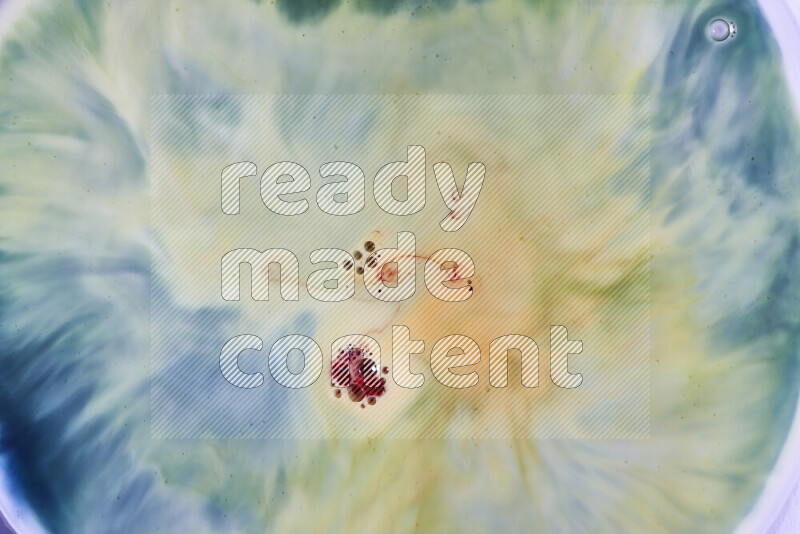 A close-up of abstract swirling patterns in green, blue and red