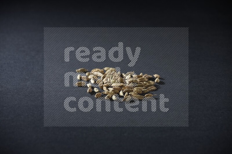 Cardamom seeds on black flooring