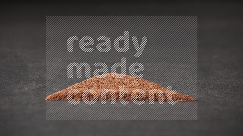 Garden cress seeds in a triangle shape on a black flooring