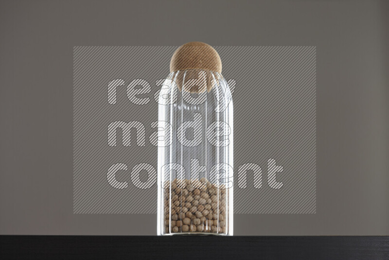 Chickpeas in a glass jar on black background