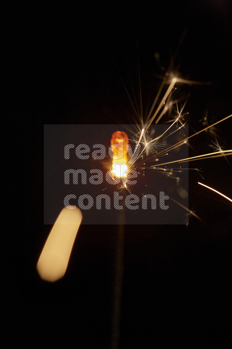 A close-up image of sparkler candle isolated on black background