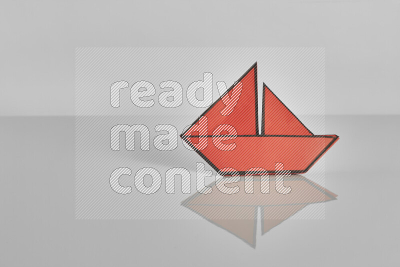 Origami boat on grey background