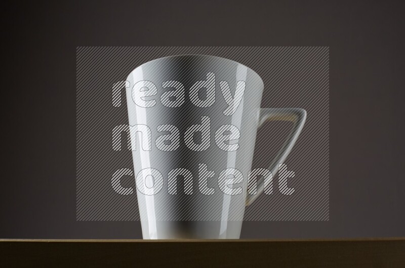 Low angle shot of a white cup on grey background