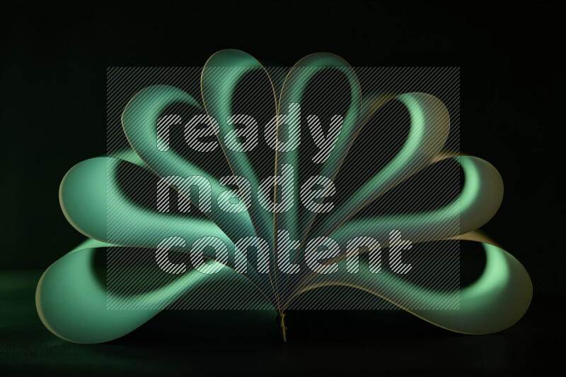 An abstract art piece displaying smooth curves in green gradients created by colored light