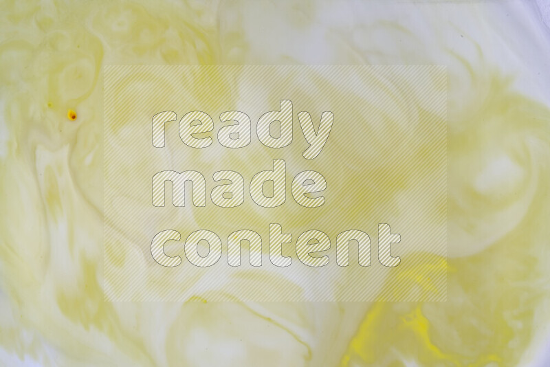 A close-up of abstract swirling patterns in yellow and white