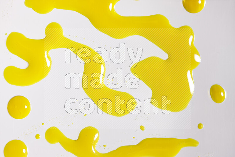 Close-ups of abstract yellow paint droplets on white background