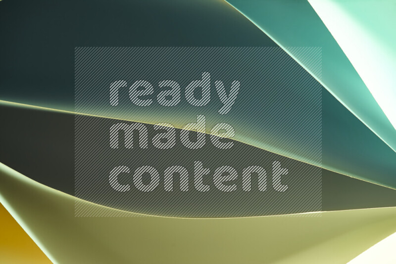 This image showcases an abstract paper art composition with paper curves in green and yellow gradients created by colored light