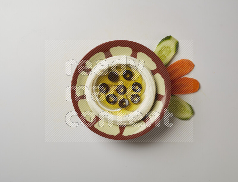 Lebnah garnished with sliced olives in a traditional plate on a white background
