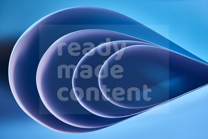 An abstract art of paper folded into smooth curves in blue gradients