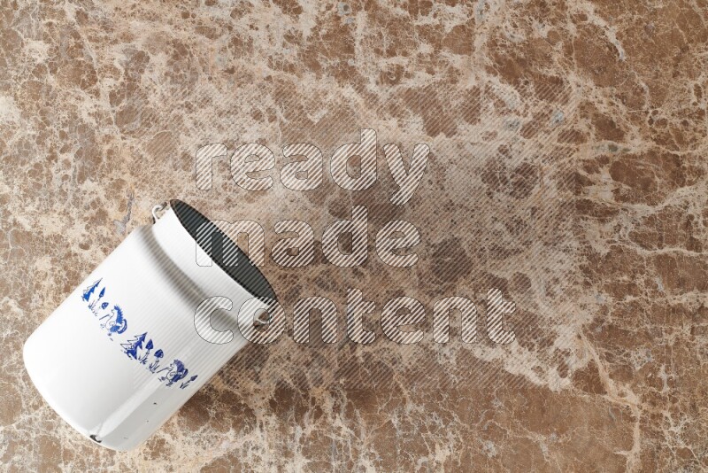 A vintage milk can on beige marble background