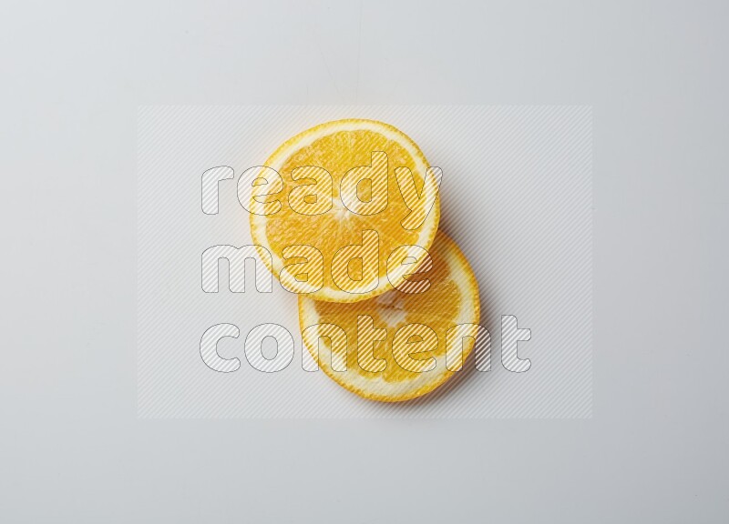 Two orange slices on white background