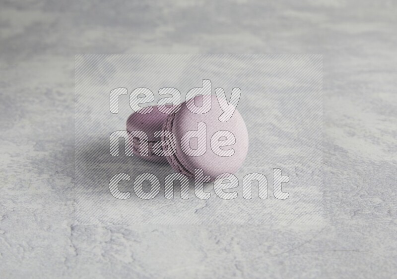 45º Shot of two Purple Blueberry macarons  on white  marble background