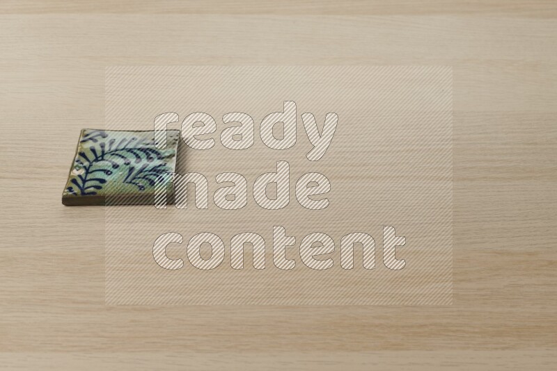 A decorative coaster on light wooden background
