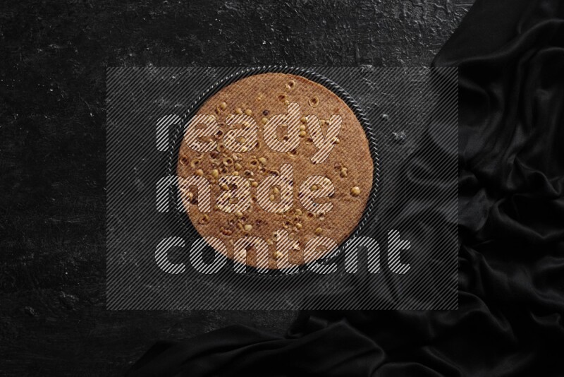 Basbousa in different plates in a dark setup