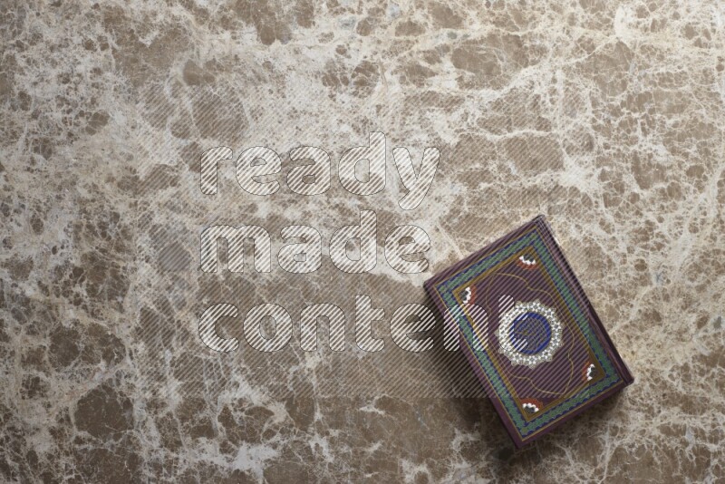 The holy Quran on beige marble background