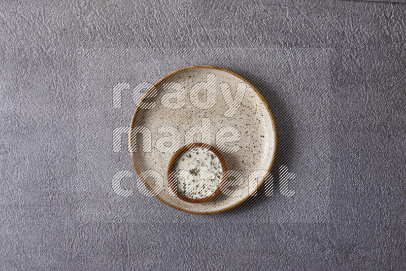 Assorted snacks in pottery bowls on grey background