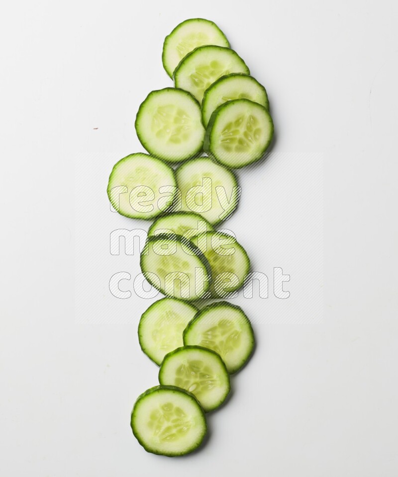 Multiple cucumber slices on white background