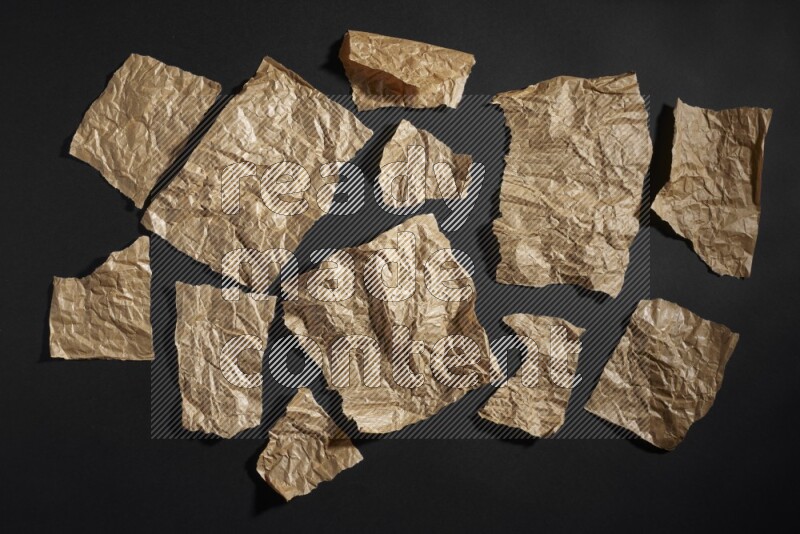 Crumpled craft paper on black background