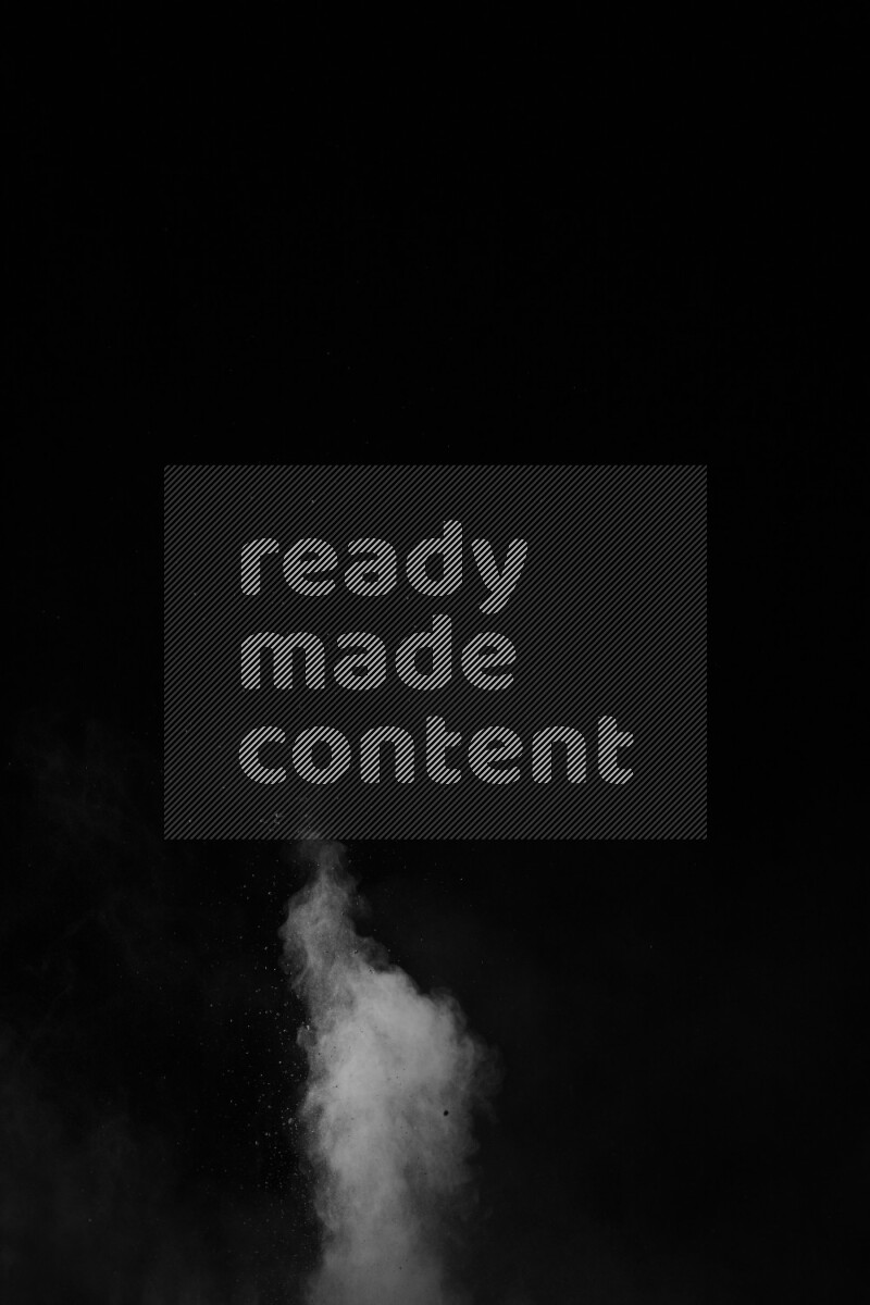 A side view of white powder explosion on black background