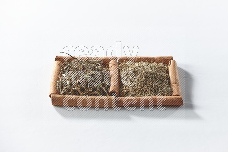 2 squares of cinnamon sticks full of dried basil and cumin on white flooring