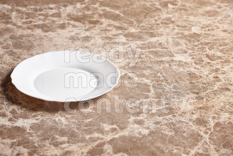 A white ceramic circular plate on beige marble background