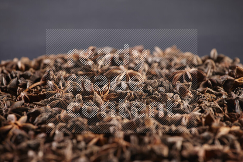 Star Anise fill the frame on black flooring