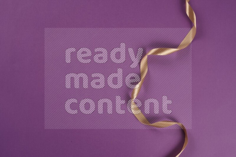 A beige collection of sewing and tailoring tools arranged on a purple background