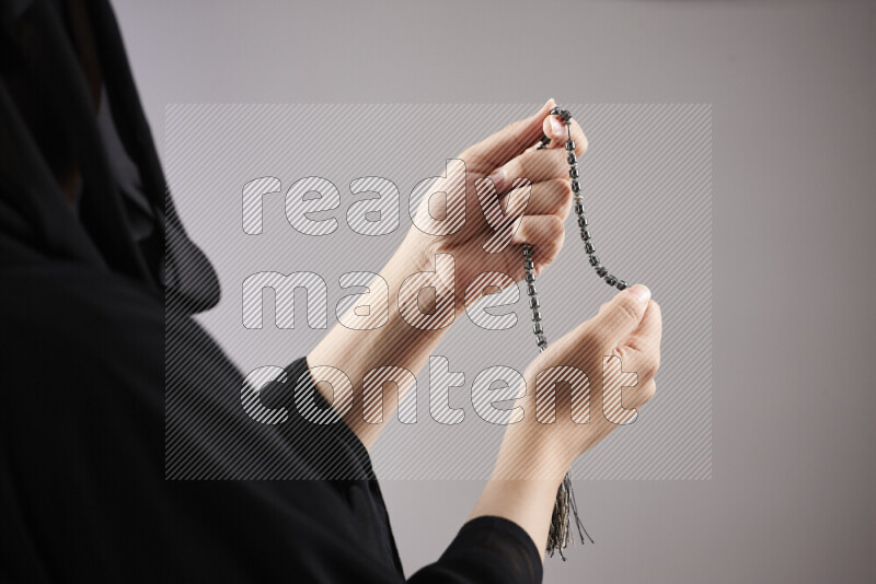 Woman hands holding praying beads (sebha) in different positions