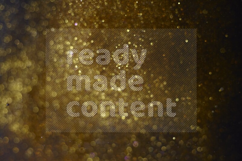 Gold glitter powder isolated on black background