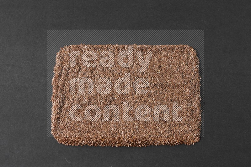 Flaxseeds Filling the Frame on a black Flooring