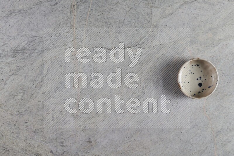 A multicolored pottery Bowl on grey marble background