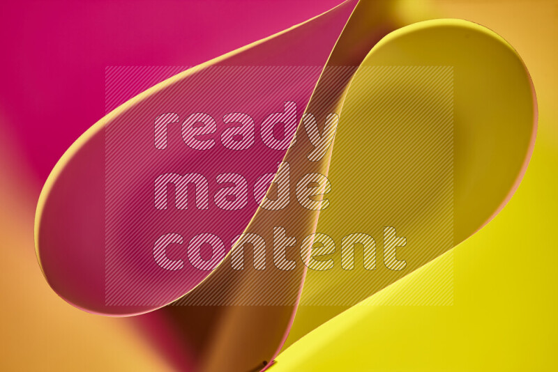 An abstract art of paper folded into smooth curves in yellow and pink gradients