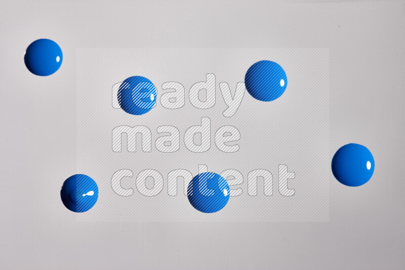 Close-ups of abstract blue paint droplets on the surface
