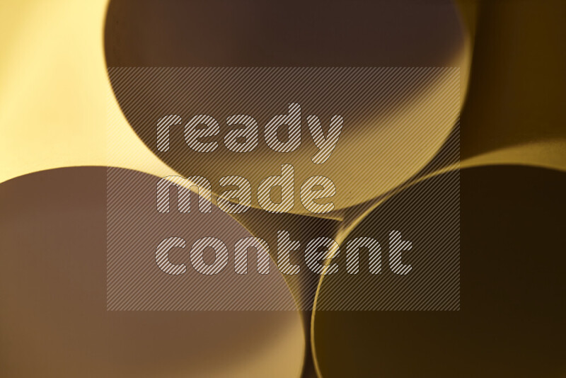 The image shows an abstract paper art with circular shapes in varying shades of gold